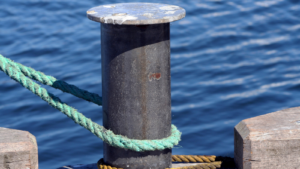 rope from a boat around a mooring by water